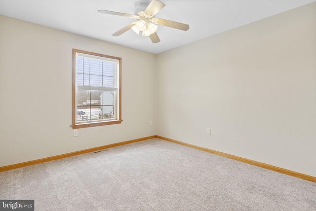 empty room featuring ceiling fan and carpet floors