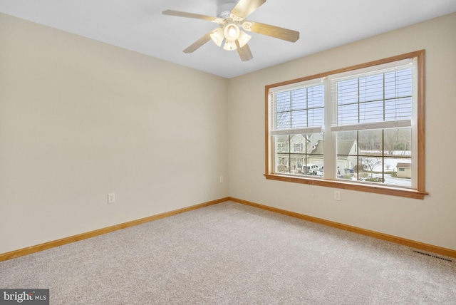 carpeted empty room featuring ceiling fan