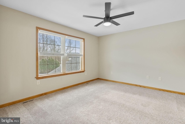 empty room featuring carpet and ceiling fan