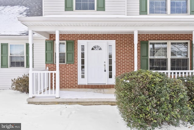 view of snow covered property entrance