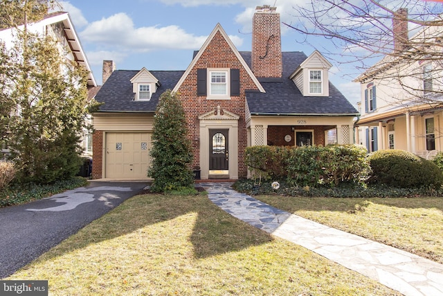 view of front of home with a garage and a front lawn