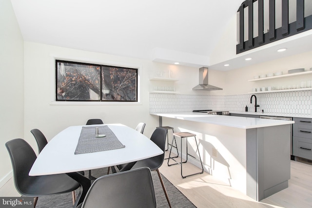 dining area with sink and light hardwood / wood-style flooring