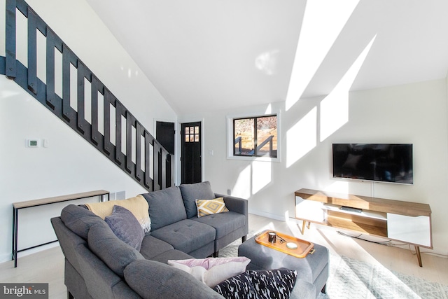 living room featuring lofted ceiling