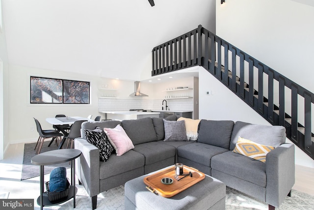 living room featuring light hardwood / wood-style floors and a high ceiling