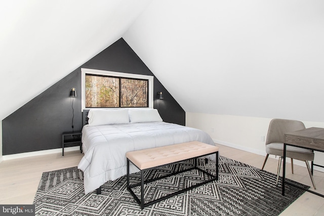 bedroom featuring wood-type flooring and vaulted ceiling