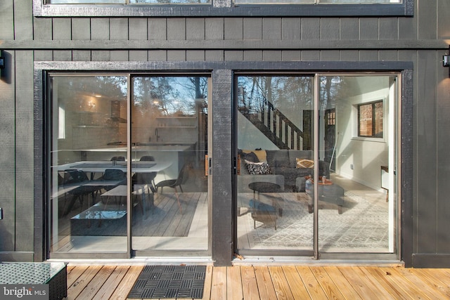 entryway with hardwood / wood-style flooring and wooden walls