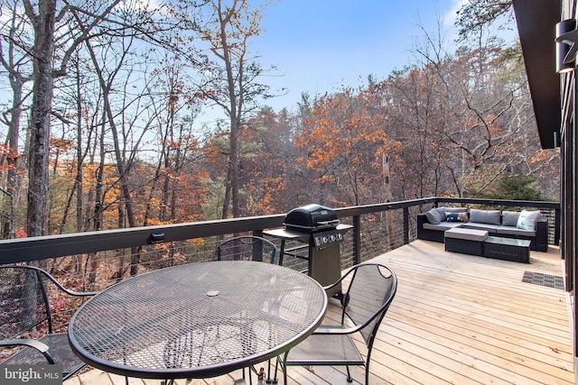 wooden terrace featuring grilling area and an outdoor hangout area