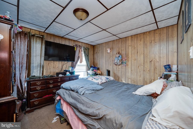 carpeted bedroom with wooden walls