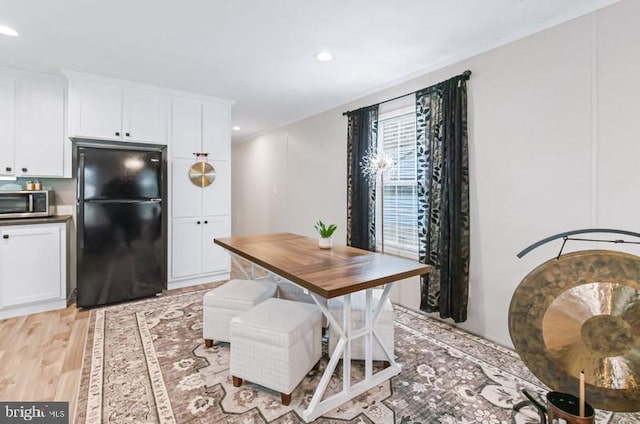 dining space featuring light wood-type flooring