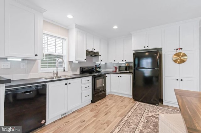 kitchen featuring white cabinetry, light hardwood / wood-style floors, sink, and black appliances