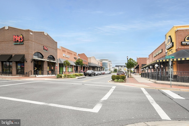 view of street with street lighting, curbs, and sidewalks