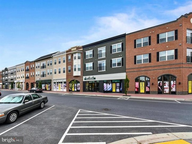 view of building exterior featuring uncovered parking