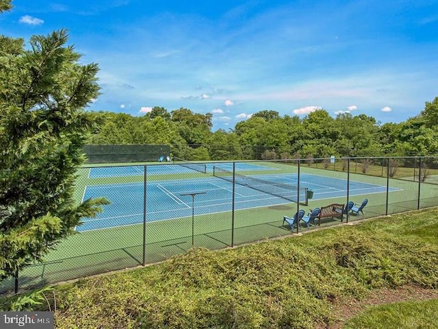 view of tennis court featuring fence