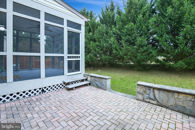 view of patio featuring a sunroom