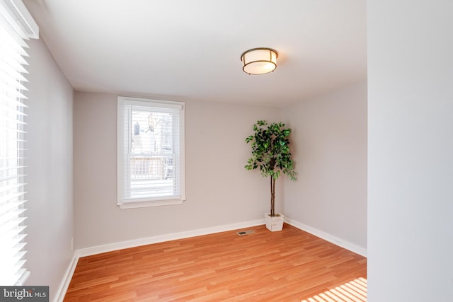 unfurnished room with hardwood / wood-style floors