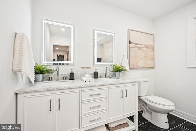 bathroom featuring vanity and toilet