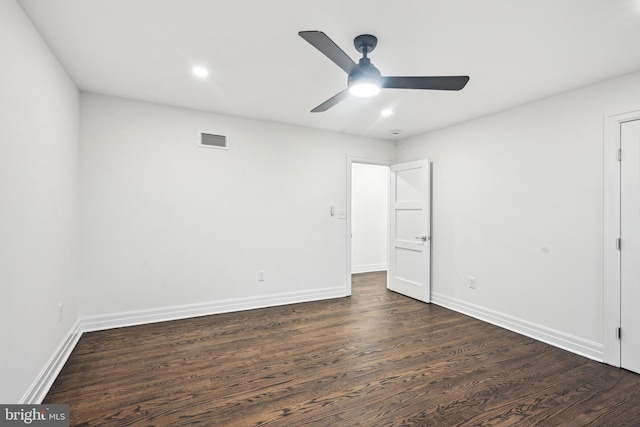 spare room featuring dark hardwood / wood-style floors and ceiling fan