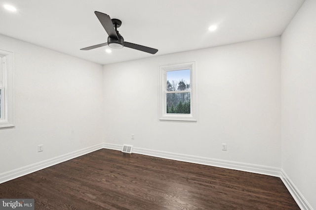 spare room featuring dark hardwood / wood-style flooring and ceiling fan