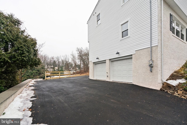 view of property exterior with a garage