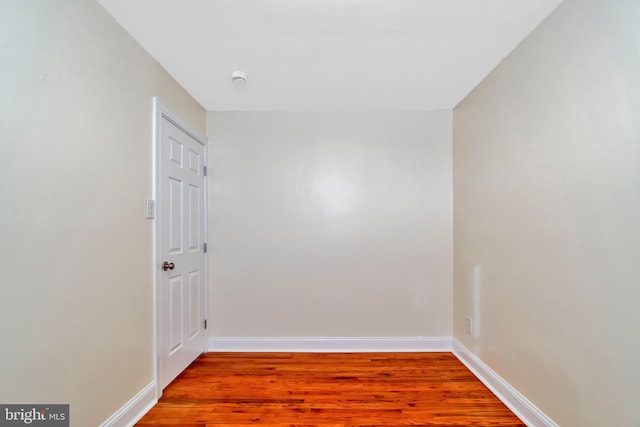 empty room with hardwood / wood-style flooring