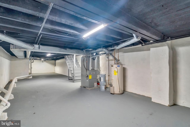 basement featuring water heater and heating unit