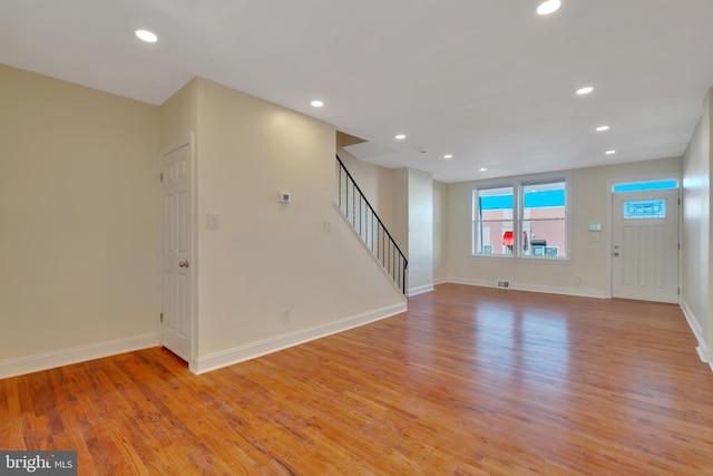 unfurnished living room featuring light wood-type flooring