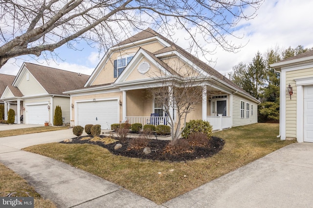 view of front of home with a garage, covered porch, and a front lawn