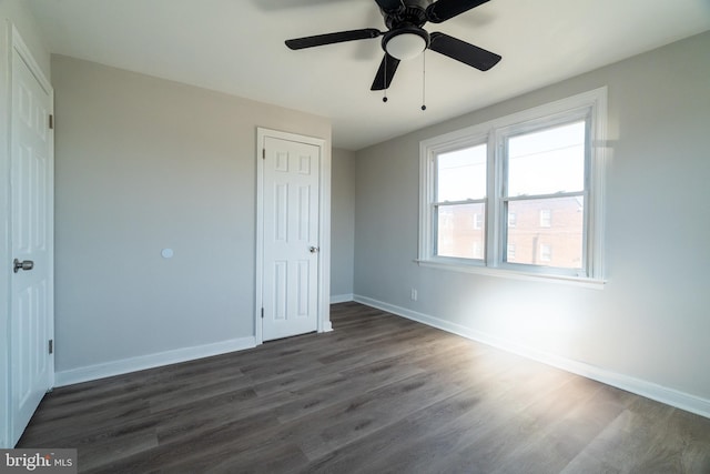 unfurnished bedroom featuring dark hardwood / wood-style flooring and ceiling fan