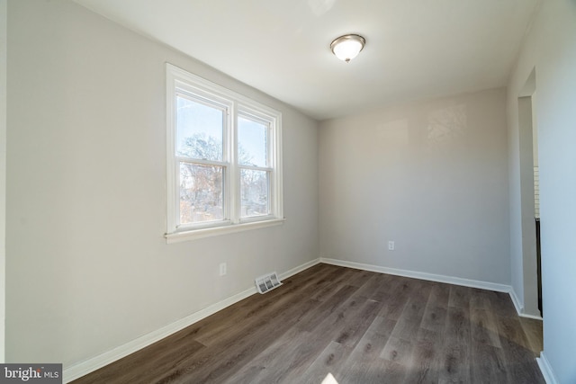 empty room featuring dark wood-type flooring