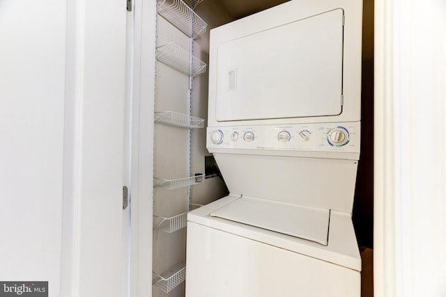 clothes washing area with stacked washer and dryer