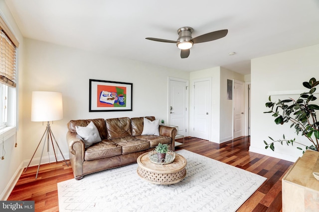 living room with dark hardwood / wood-style floors and ceiling fan