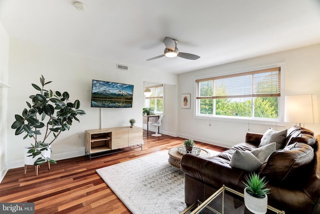 living room with ceiling fan and dark hardwood / wood-style floors