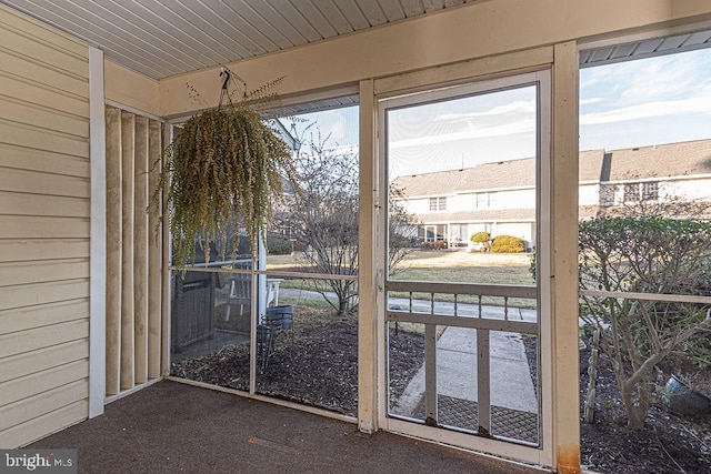 doorway to outside featuring wood walls