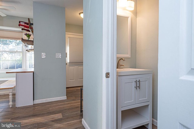 bathroom featuring hardwood / wood-style flooring, vanity, and ceiling fan