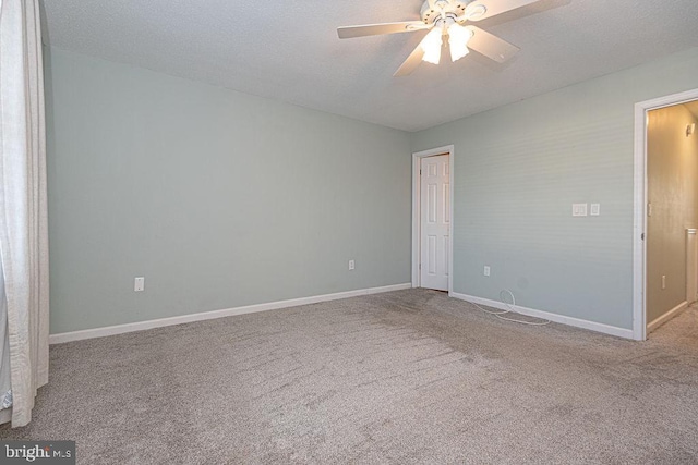 spare room featuring light carpet, a textured ceiling, and ceiling fan