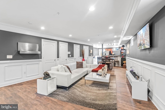 living room featuring ornamental molding and hardwood / wood-style floors