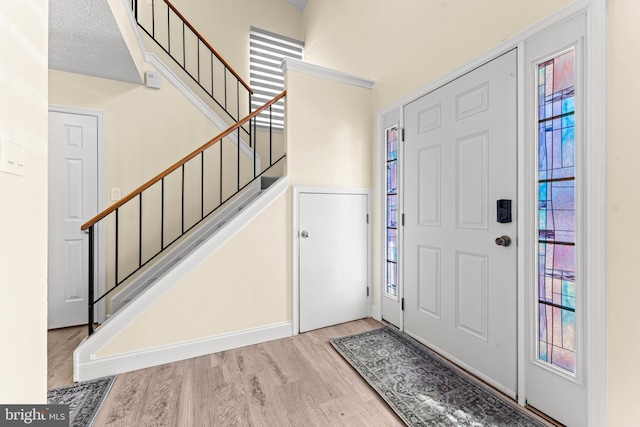 entrance foyer with a healthy amount of sunlight and light hardwood / wood-style floors