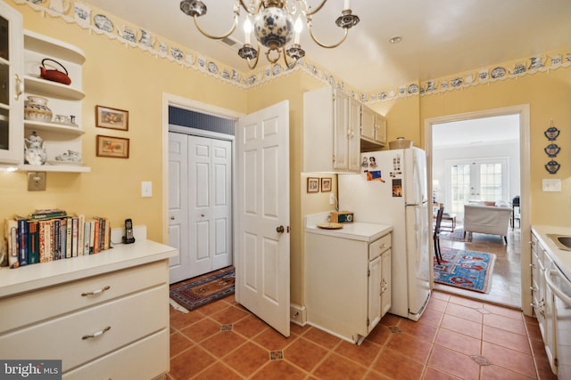 kitchen featuring french doors, tile patterned floors, white fridge, and white cabinets