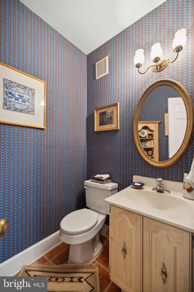 bathroom with vanity, tile patterned floors, and toilet