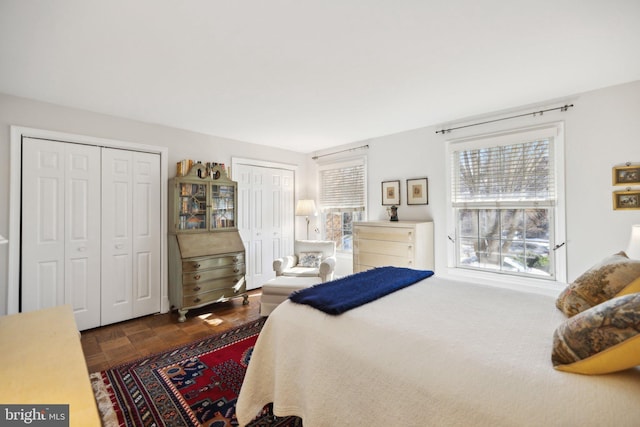 bedroom featuring multiple closets