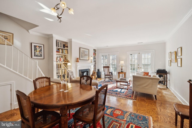 dining area with ornamental molding, french doors, and light parquet floors