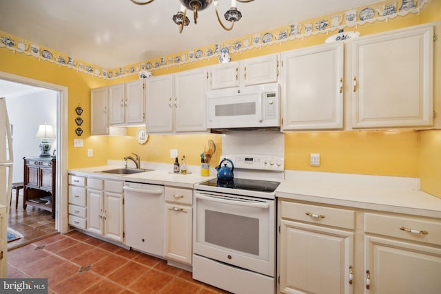 kitchen with white cabinetry, white appliances, tile patterned flooring, and sink