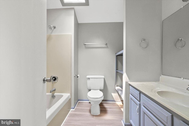 full bathroom featuring vanity, wood-type flooring, toilet, and  shower combination