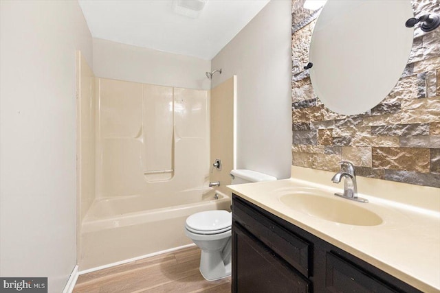 full bathroom featuring hardwood / wood-style flooring, vanity, toilet, and tub / shower combination