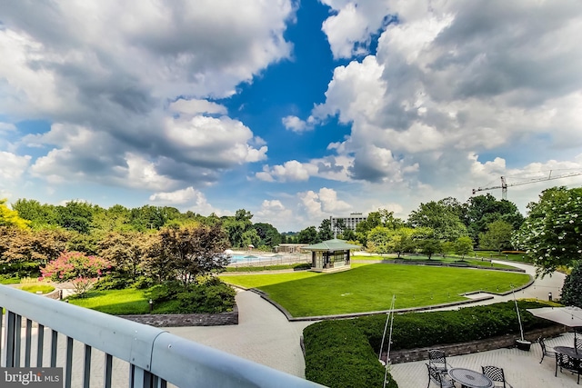 surrounding community featuring a gazebo, a swimming pool, and a lawn