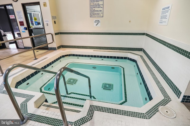 view of swimming pool featuring an indoor in ground hot tub