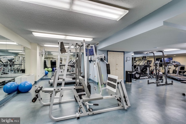 exercise room featuring a textured ceiling