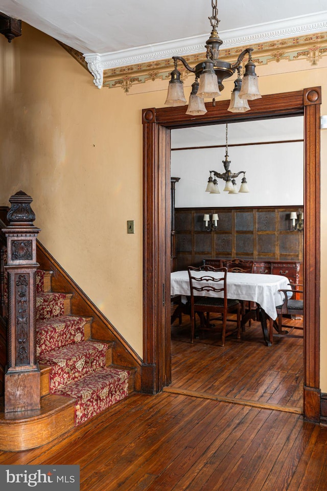 interior space with an inviting chandelier, stairs, and dark wood-style flooring