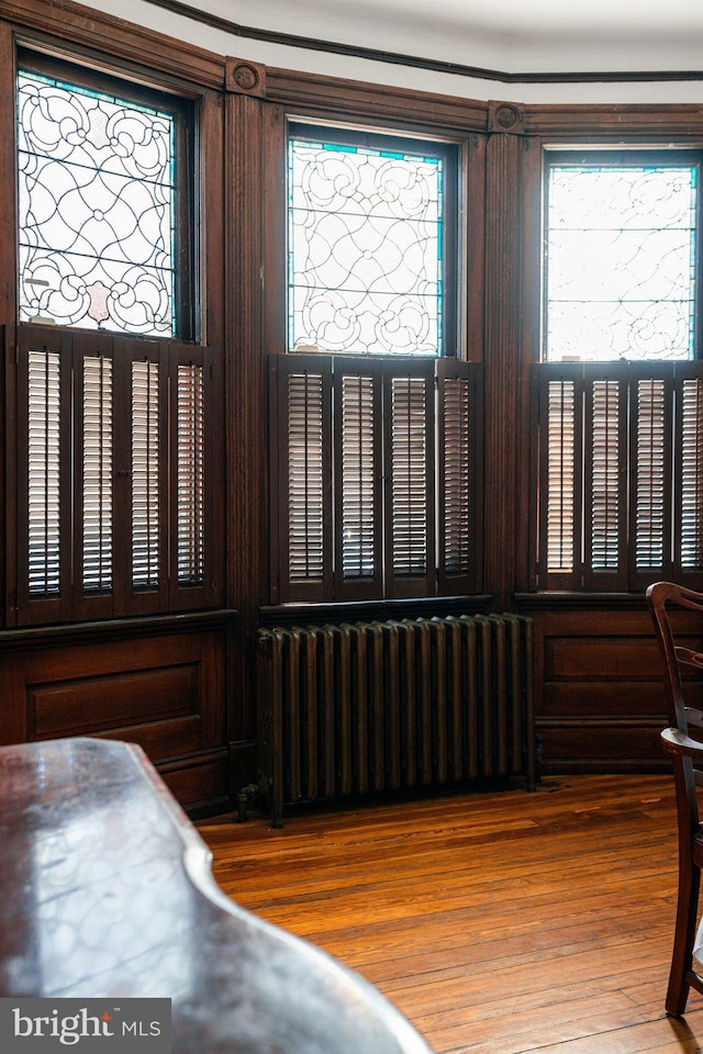 interior space featuring radiator and wood finished floors