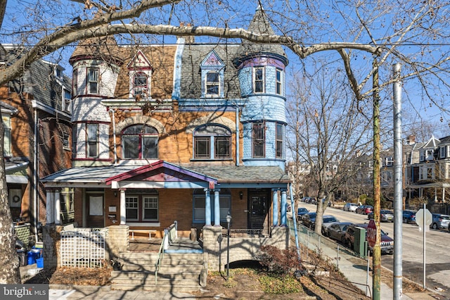 view of front of property featuring a porch and brick siding